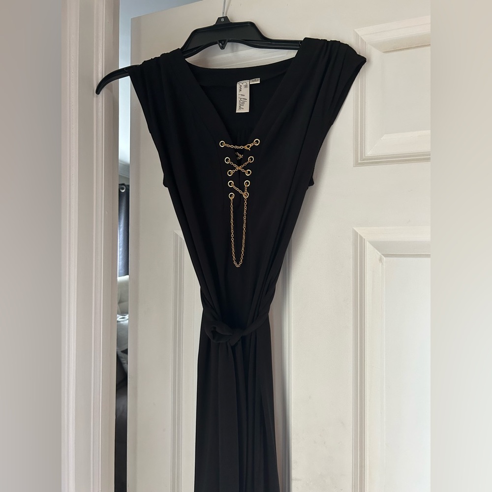 Women’s size Small black dress with gold chain detail.